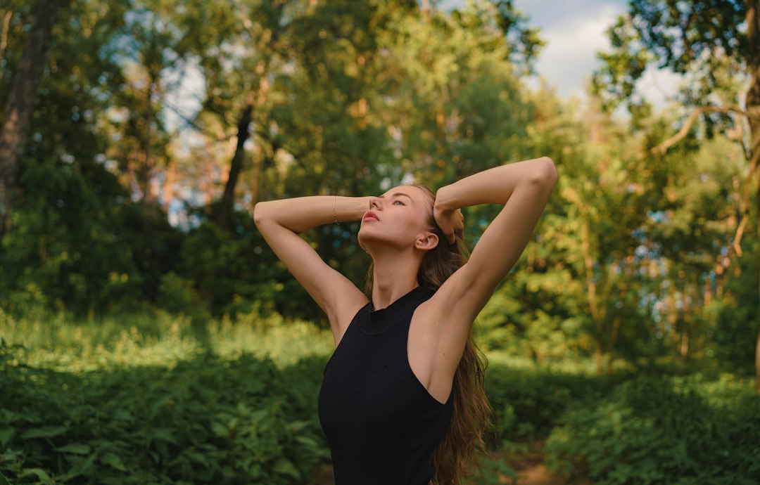 Person calmly preparing a morning wellness routine at a sunlit kitchen counter, looking confident and intentional